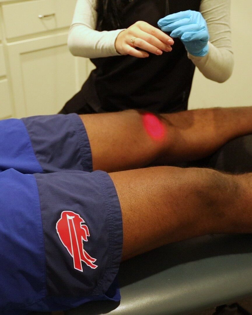 High-intensity laser therapy applied to a patient's knee at Acadiana Pain & Performance Rehab