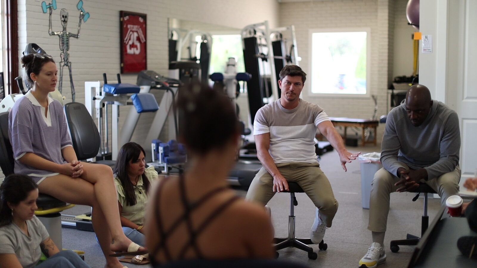 Dr. Hines leading a team workshop session in the gym