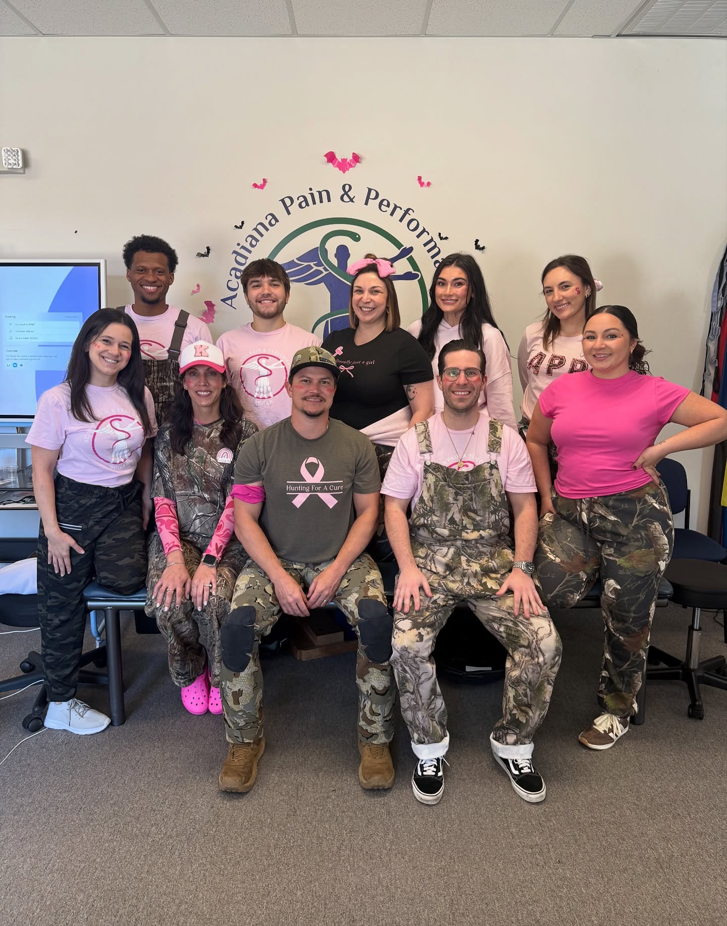 Acadiana Pain & Performance Rehab team wearing breast cancer awareness shirts